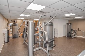 a gym with cardio machines and other equipment in a building